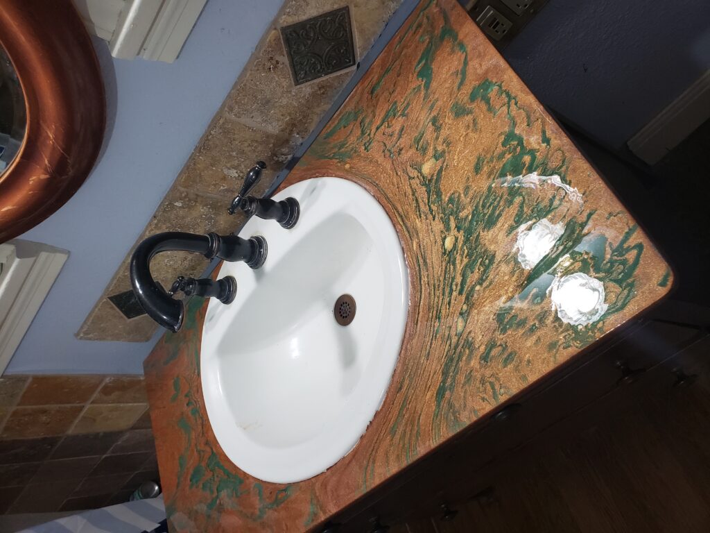 Custom metallic copper and emerald epoxy bathroom sink counter 
